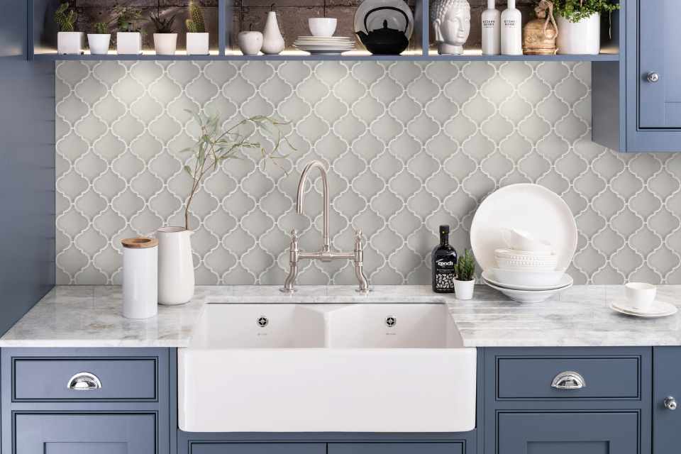 Moroccan style backsplash in kitchen with blue cupboards